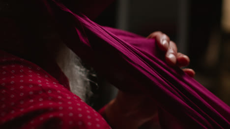 Close-Up-Low-Key-Studio-Lighting-Shot-Of-Senior-Sikh-Man-With-Beard-Tying-Fabric-For-Turban-Against-Dark-Background-4